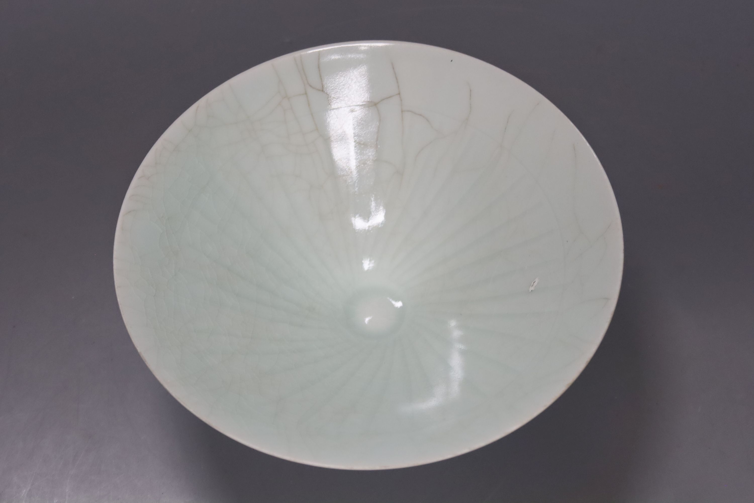 A Chinese celadon glazed vase, height 28cm, together with a crackle glaze bowl, a blue and white teabowl and saucer and a blue and white dish